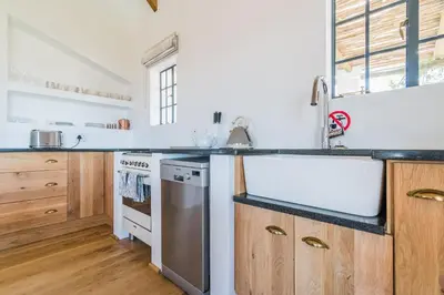 a kitchen with a sink and a stove at Druk My Niet Wine Estate in Paarl