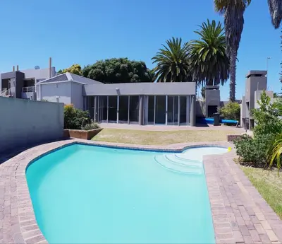an image of a swimming pool in front of a house at D'urban Ridge Self catering Apartment in Cape Town