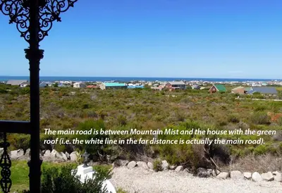 a sign for the main road is between mountain must and the house at Mountain Mist in Bettyʼs Bay