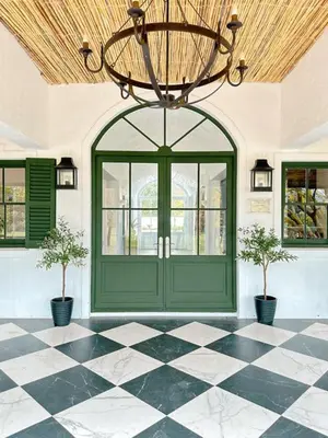 a room with a green door and a checkered floor at Huguenot House in Franschhoek