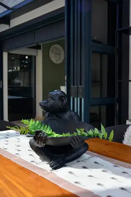 a statue of a bird sitting on a table at Crown Comfort - Affordable luxury - Private Heated Pool & Hot Tub Under Roof in Cape Town