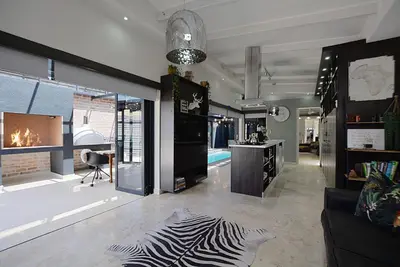a living room with a zebra rug on the floor at Crown Comfort - Affordable luxury - Private Heated Pool & Hot Tub Under Roof in Cape Town