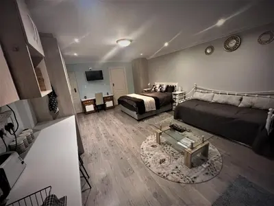a living room with a couch and a bed at Ridgeworth, Tygervalley in Cape Town