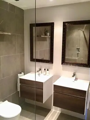 a bathroom with two sinks and a toilet and a shower at Dolphin Beach Cabana in Table View