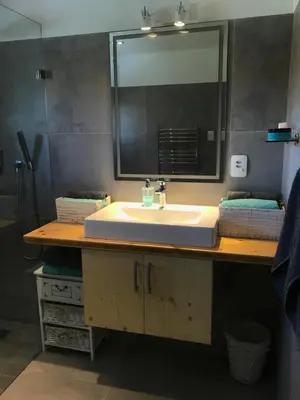 a bathroom with a sink and a mirror at African Holiday home in Table View in Cape Town