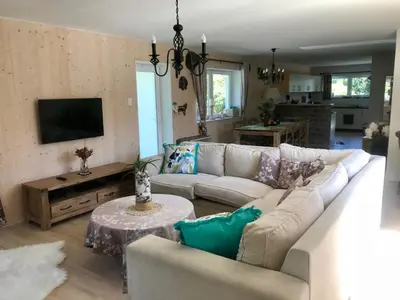 a living room with a couch and a table at African Holiday home in Table View in Cape Town