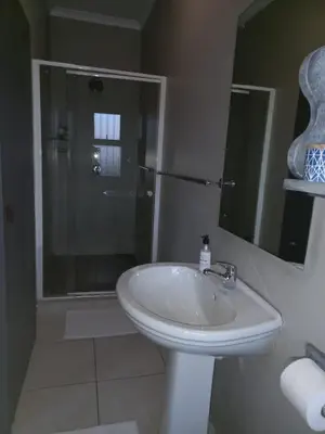 a bathroom with a sink and a glass shower at Eagle's Crest in Worcester