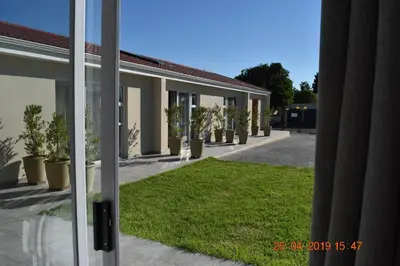 an open door of a building with a grass yard at Pringle Nest in Cape Town