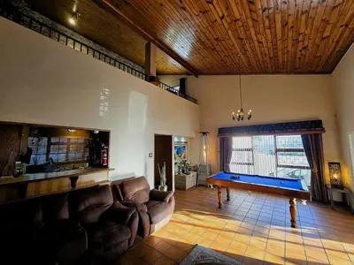 a living room with a couch and a pool table at Walters Lane Luxury Accommodation main house - No loadshedding in Cape Town