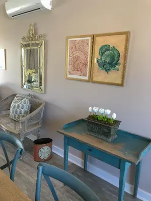 a room with a blue table with flowers on it at The Lemon Tree in Franschhoek in Franschhoek