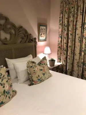 a bed with two pillows and a lamp in a bedroom at The Lemon Tree in Franschhoek in Franschhoek