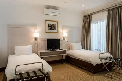 a hotel room with two beds and a television at Val Du Charron Wine & Leisure Estate in Wellington