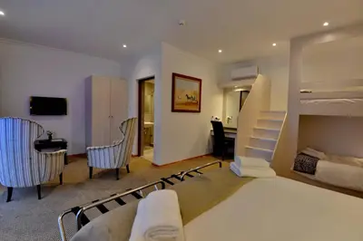a bedroom with a bunk bed and a desk at Val Du Charron Wine & Leisure Estate in Wellington