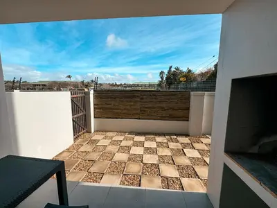a balcony with a checkered tile floor on a house at Nemesia Court in Durbanville