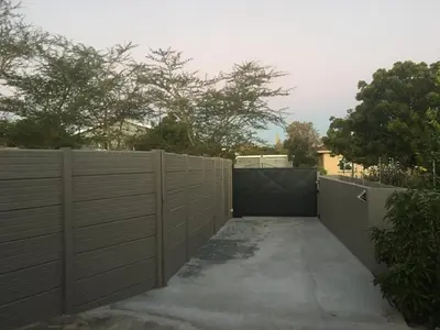 a privacy fence with a gate in a driveway at Ammabed Accommodation in Caledon