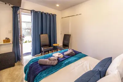 a bedroom with a bed with towels on it at Ammabed Accommodation in Caledon