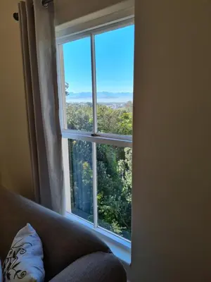 a window in a room with a couch looking out at Bell Rosen Guest House in Bellville