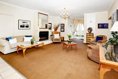 a living room with a couch and a table at Bell Rosen Guest House in Bellville