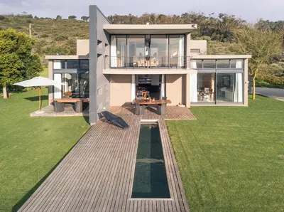 a large house with a large yard with a lawn sidx sidx sidx at Stellar Guest Villa on Stunning Wine Farm in Cape Town