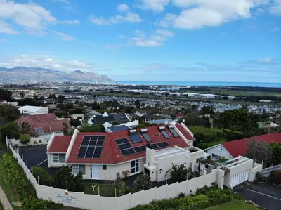a house with solar panels on the roof at Somerset View Guest House in Somerset West
