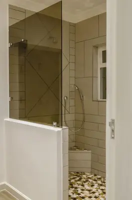 a shower with a glass door in a bathroom at Somerset View Guest House in Somerset West