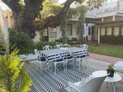 a table and chairs sitting on a patio at Sandown Lodge in Cape Town