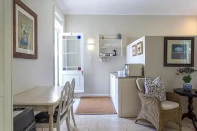 a kitchen and dining room with a table and chairs at Sandown Lodge in Cape Town