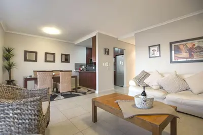 a living room with a couch and a table at 2 Bedroom apartment with Breathtaking Views! in Cape Town