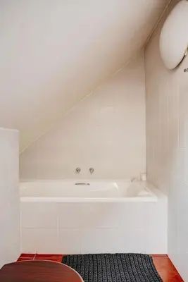 a bathroom with a bath tub and a sink at Le Arc Manor House in Franschhoek