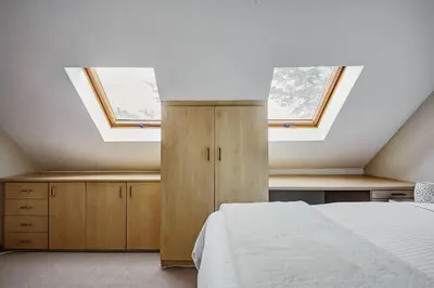 a bedroom with a bed and two skylights at Le Arc Manor House in Franschhoek