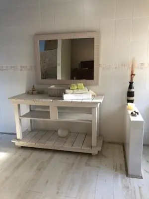 a table with a mirror in a room at The Vineyard East in Joostenberg Vlakte