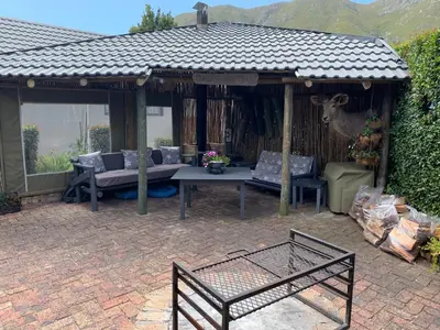 a gazebo with a table and a deer in it at Bem Vindo Self Catering Guest House in Hermanus