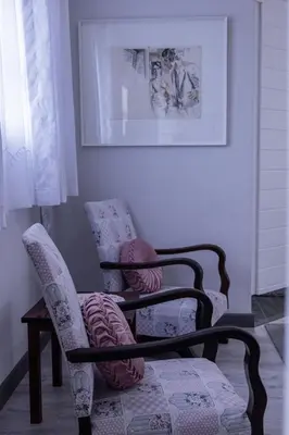 two chairs sitting in a living room next to a window at Bem Vindo Self Catering Guest House in Hermanus