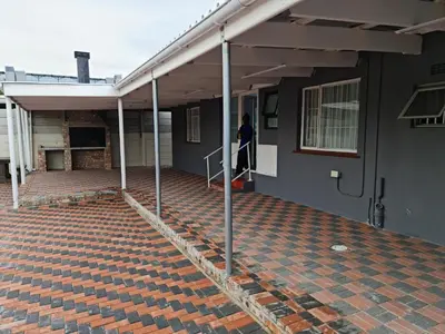 a person walking up the stairs of a house at Hasate Guest House 10 Florence street Oakdale Belliville 7530 cape town south African in Cape Town