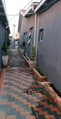 a brick walkway in front of a building at Hasate Guest House 10 Florence street Oakdale Belliville 7530 cape town south African in Cape Town