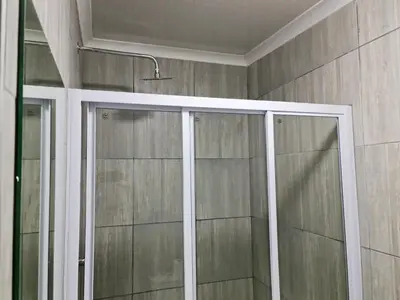a shower with glass doors in a bathroom at Hasate Guest House 10 Florence street Oakdale Belliville 7530 cape town south African in Cape Town