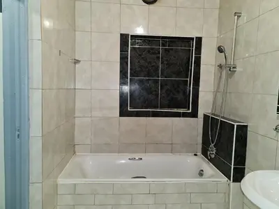 a bathroom with a bath tub and a sink at Hasate Guest House 10 Florence street Oakdale Belliville 7530 cape town south African in Cape Town