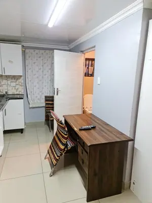 a kitchen with a wooden desk in a room at Hasate Guest House 10 Florence street Oakdale Belliville 7530 cape town south African in Cape Town