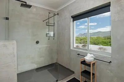 a bathroom with a shower and a window at 49 Whalerock in Hermanus