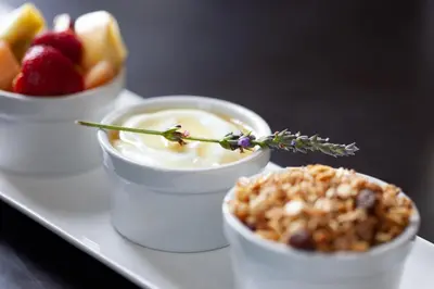 a tray with three small bowls of food and fruit at Elgin Vintners Country House in Elgin