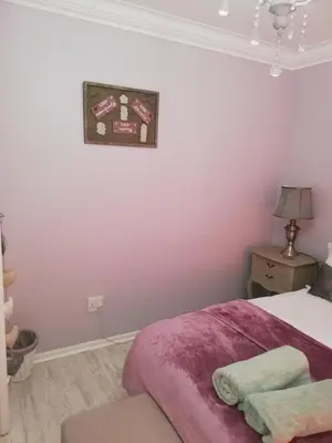 a bedroom with a bed and a picture on the wall at 504 Witsand in Bloubergstrand