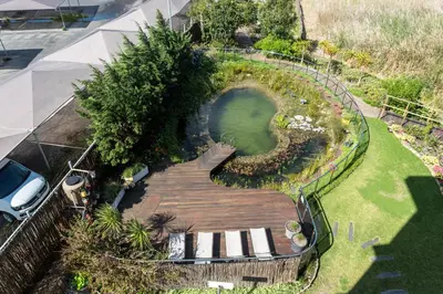 an overhead view of a garden with a wooden walkway at Hotel Verde Cape Town Airport in Matroosfontein