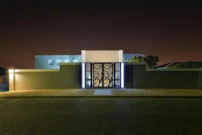 a house with a lit up door at night at Kianga in Gordonʼs Bay