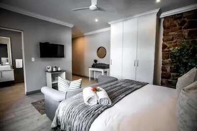 a bedroom with a large bed with two pillows at Whale Coast Ocean Villa in Hermanus