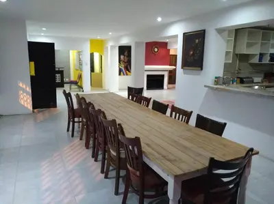 a dining room with a wooden table and chairs at Liziwe's Guest House in Matroosfontein