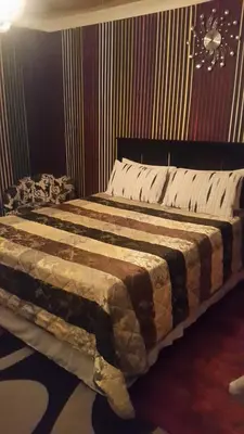 a bedroom with a large bed in a room at Liziwe's Guest House in Matroosfontein