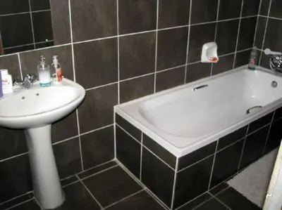 a bathroom with a sink and a bath tub at Liziwe's Guest House in Matroosfontein