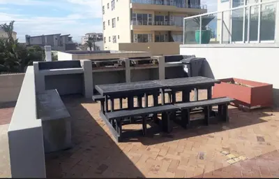 two benches sitting on top of a building at Sea Spray in Bloubergstrand