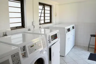 a white laundry room with a washer and dryer at Broadway Self Catering Apartments in Durbanville