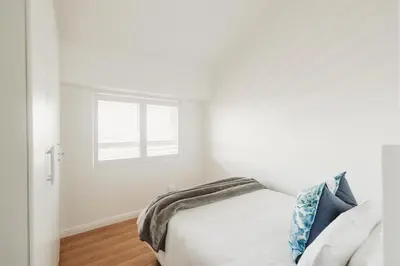 a bedroom with a bed and a window at Voir la Mer - Blouberg Beach in Bloubergstrand